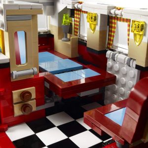 Colorful LEGO diner interior playset with a cozy table, chairs, and vintage-style counter.