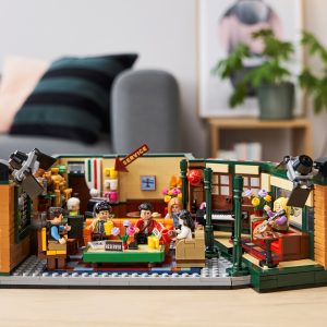Colorful LEGO café interior with lively characters, drinks, and cozy reading nook.