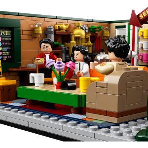 Colorful LEGO café interior with cozy seating, warm lighting, and cheerful minifigures enjoying beverages.