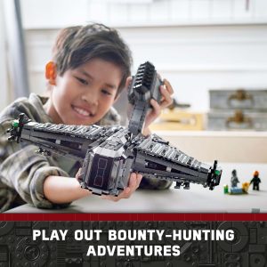 Young boy enjoys imaginative play with detailed bounty hunter spaceship model in bright, playful space.