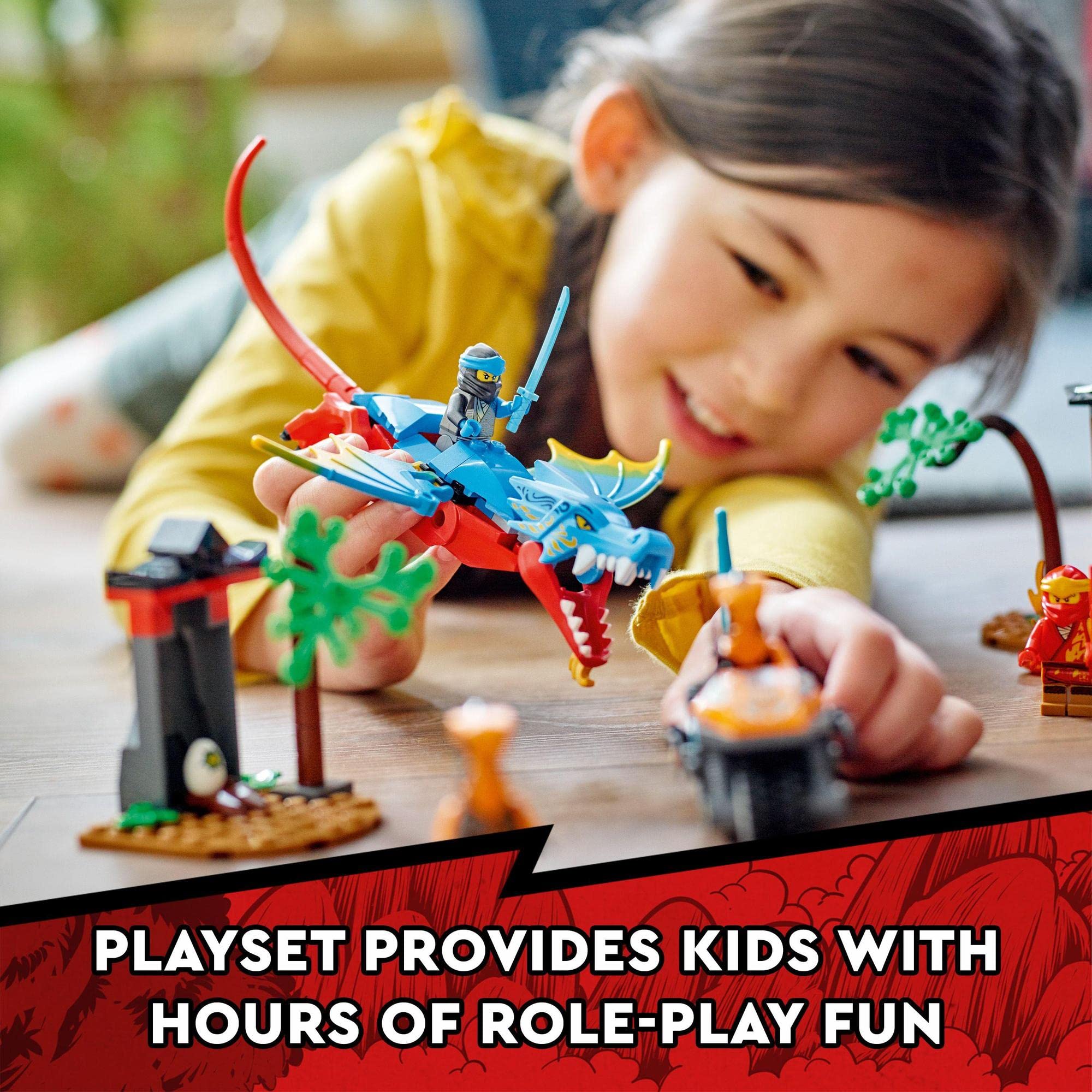 Young girl in a yellow sweater plays with a colorful dragon toy set on wooden floor.