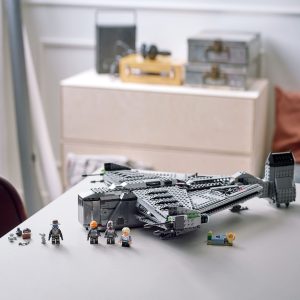 LEGO spaceship adventure scene with minifigures and accessories on a bright wooden table.
