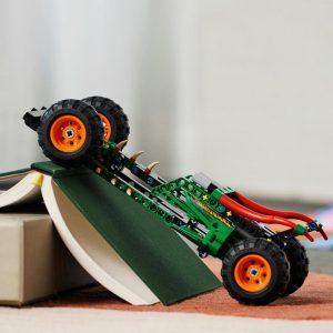 Vibrant green toy tractor climbing a book ramp in a cozy playroom setting.