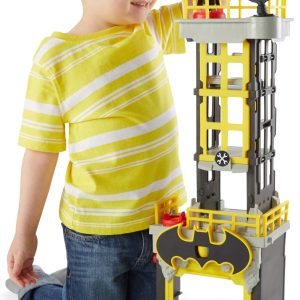Young boy joyfully plays with a vibrant Batman toy, sparking creativity and imagination.