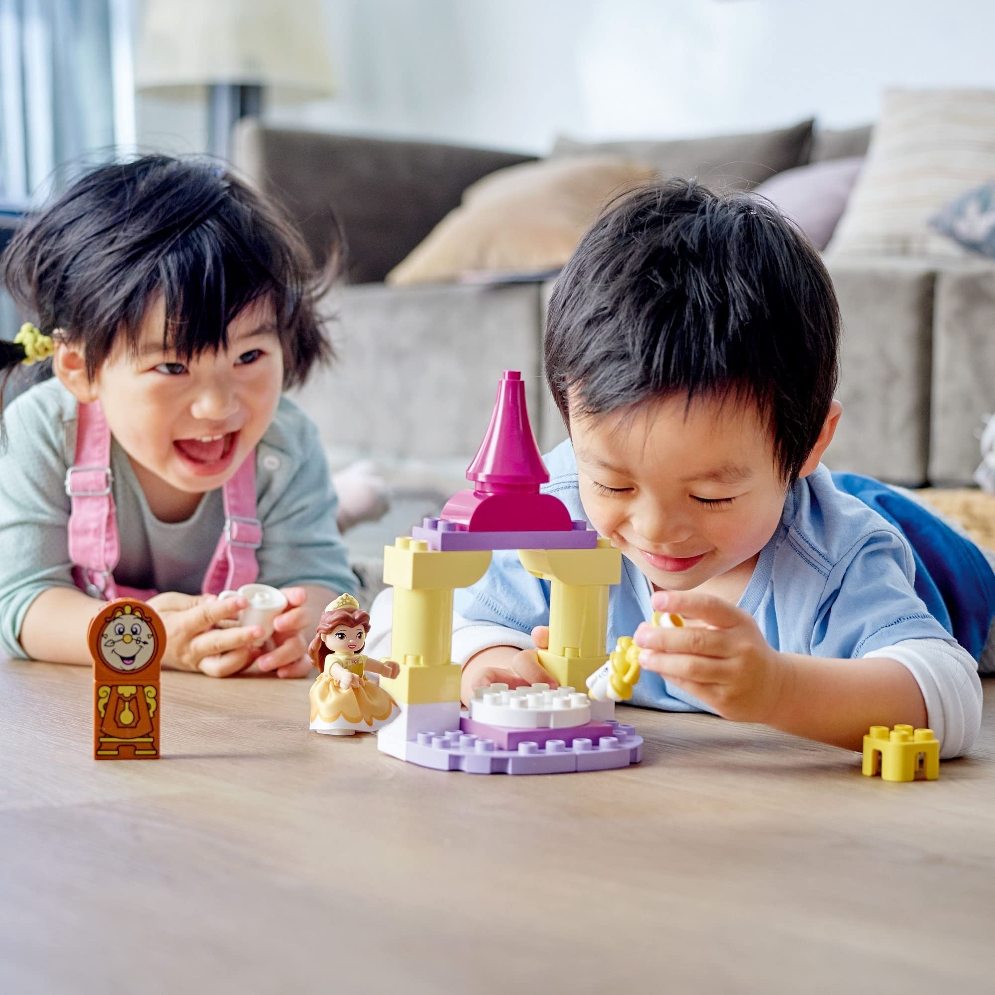 Children enjoy imaginative play with colorful toys in a bright, cozy living room.