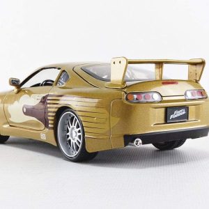 Glossy golden sports car diecast model featuring sleek design, serpent graphic, rear spoiler, and detail-rich wheels.