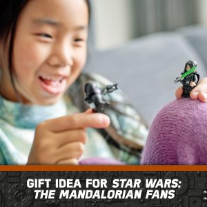 Joyful girl playing with Star Wars: The Mandalorian action figures on a cozy couch.