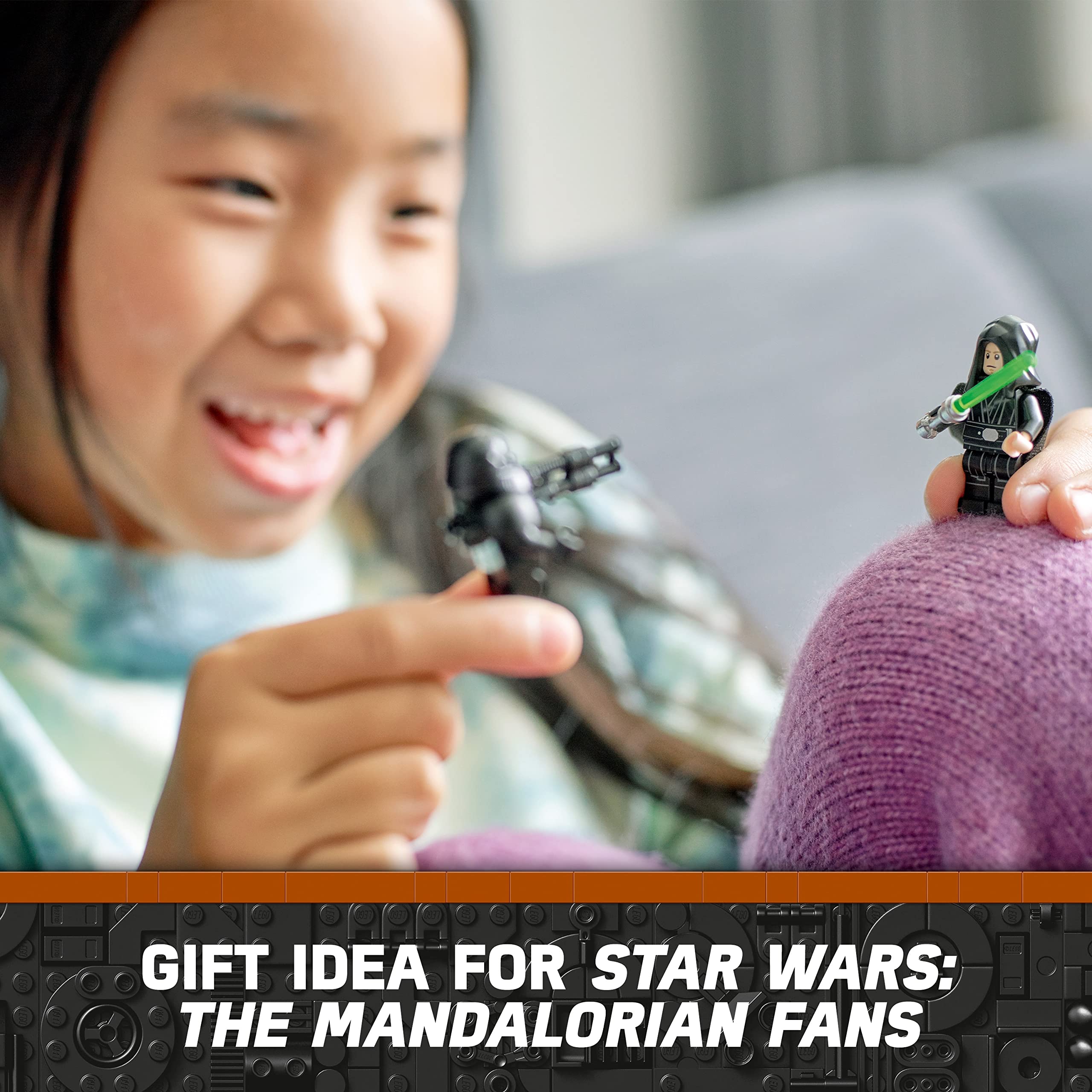 Joyful girl playing with Star Wars: The Mandalorian action figures on a cozy couch.