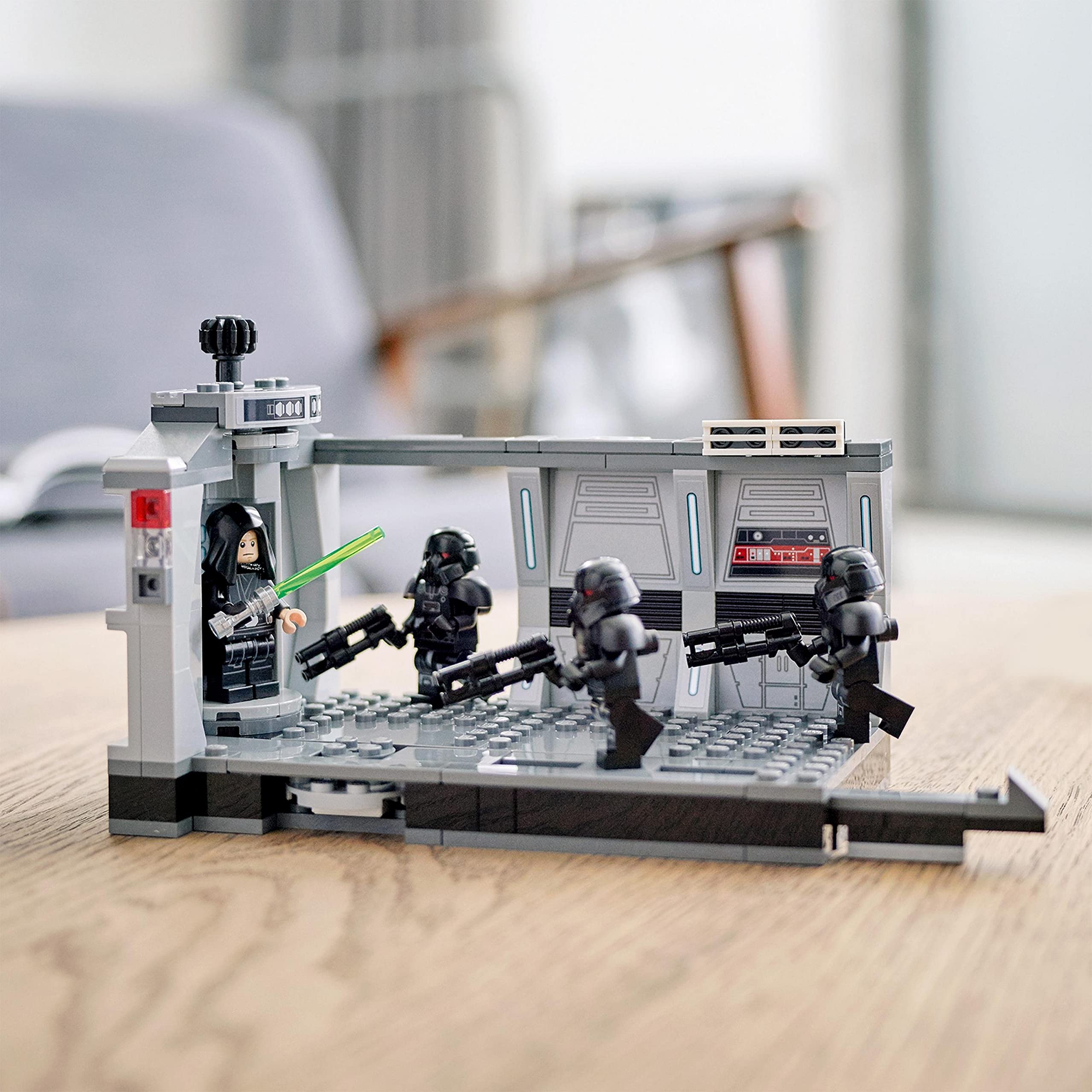 LEGO sci-fi duel in command room: lightsaber versus troopers in a dramatic, high-tech scene.