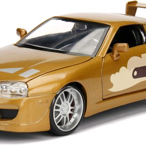 Gold Toyota Supra die-cast model with flame graphics, showcasing its high-performance design and legacy.