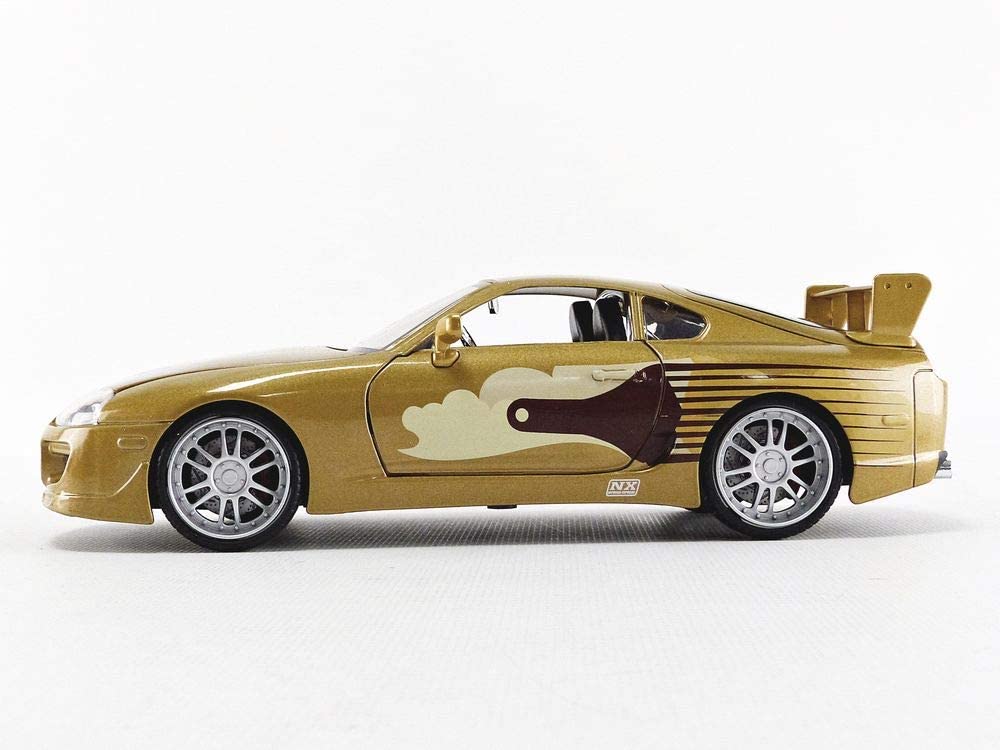 Metallic gold Toyota Supra die-cast model with sleek design and creative artistic details.