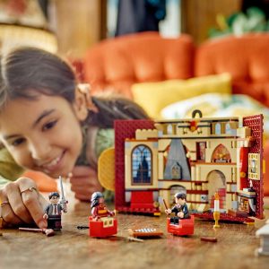 Girl happily plays with a colorful LEGO set, sparking creativity in a cozy room.
