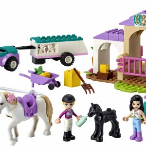 Colorful LEGO horse stable playset with figurines, horses, and vehicles for imaginative adventures.