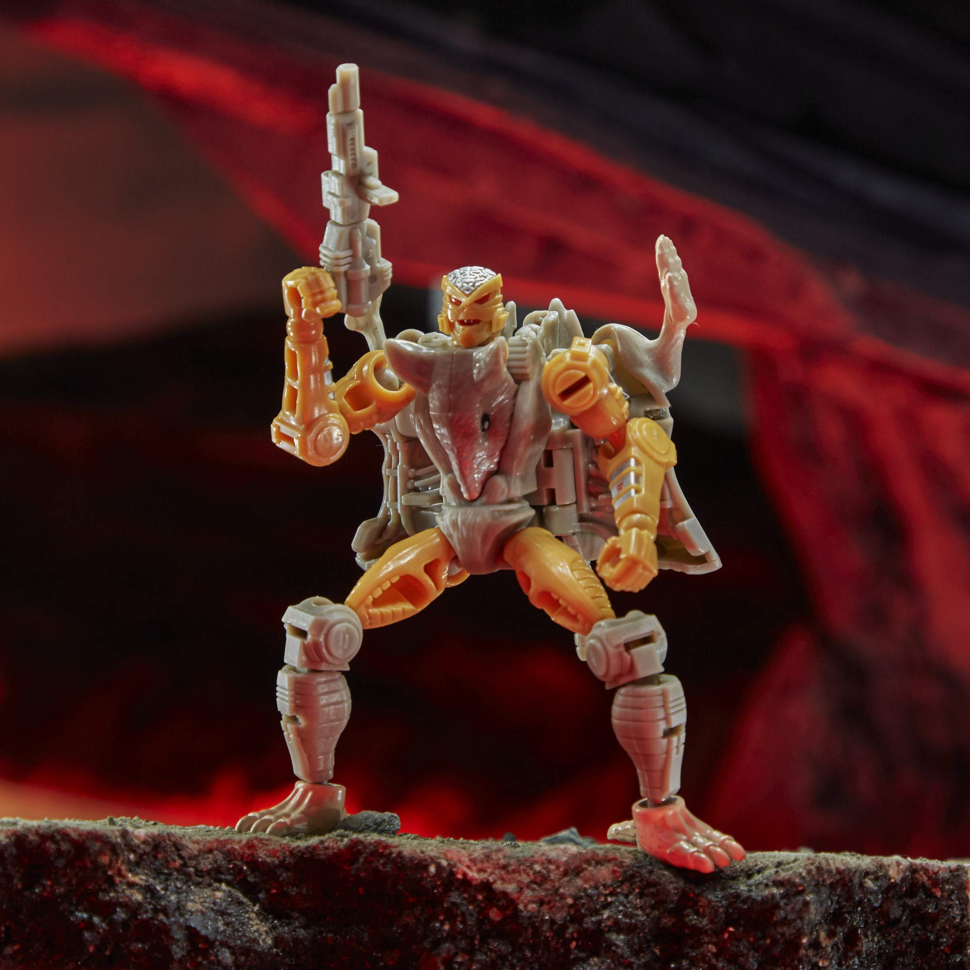 Action figure of a warrior in fiery landscape, showcasing intricate design and advanced weaponry.