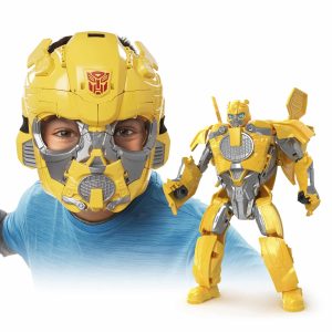 Child in Bumblebee helmet smiles next to action figure, celebrating imaginative play and adventure.