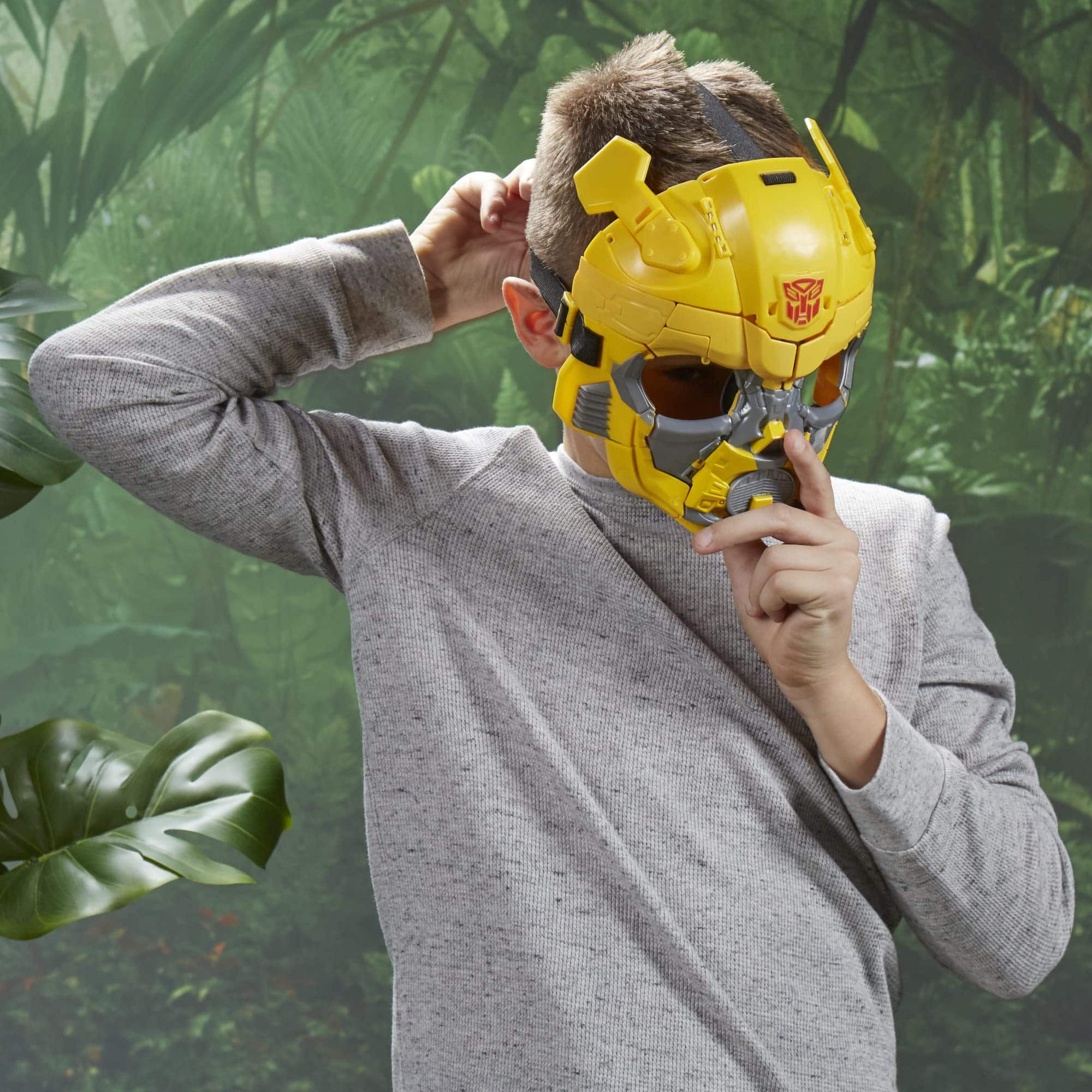 Child in Bumblebee mask explores a vibrant jungle, embodying playful imagination and adventure.