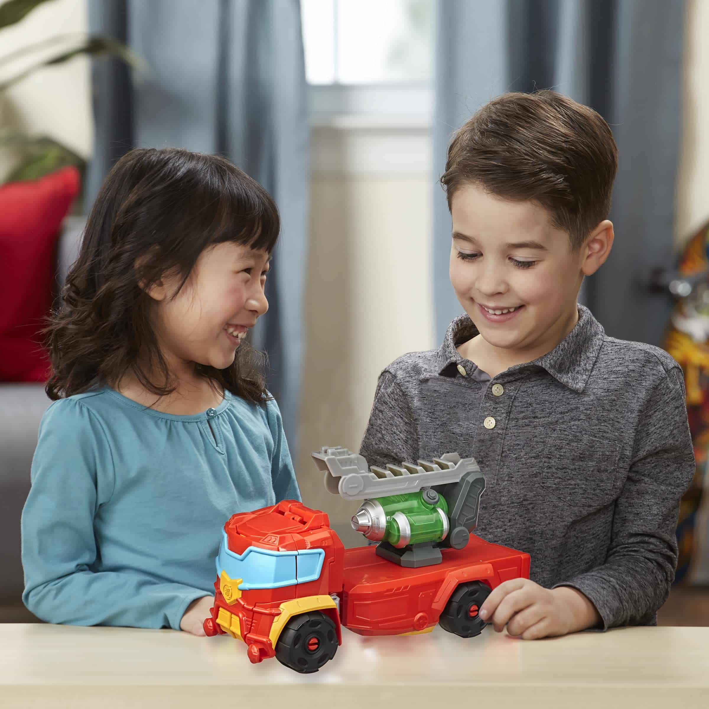Joyful children play with a vibrant fire truck, sparking imagination and friendship in a cozy room.