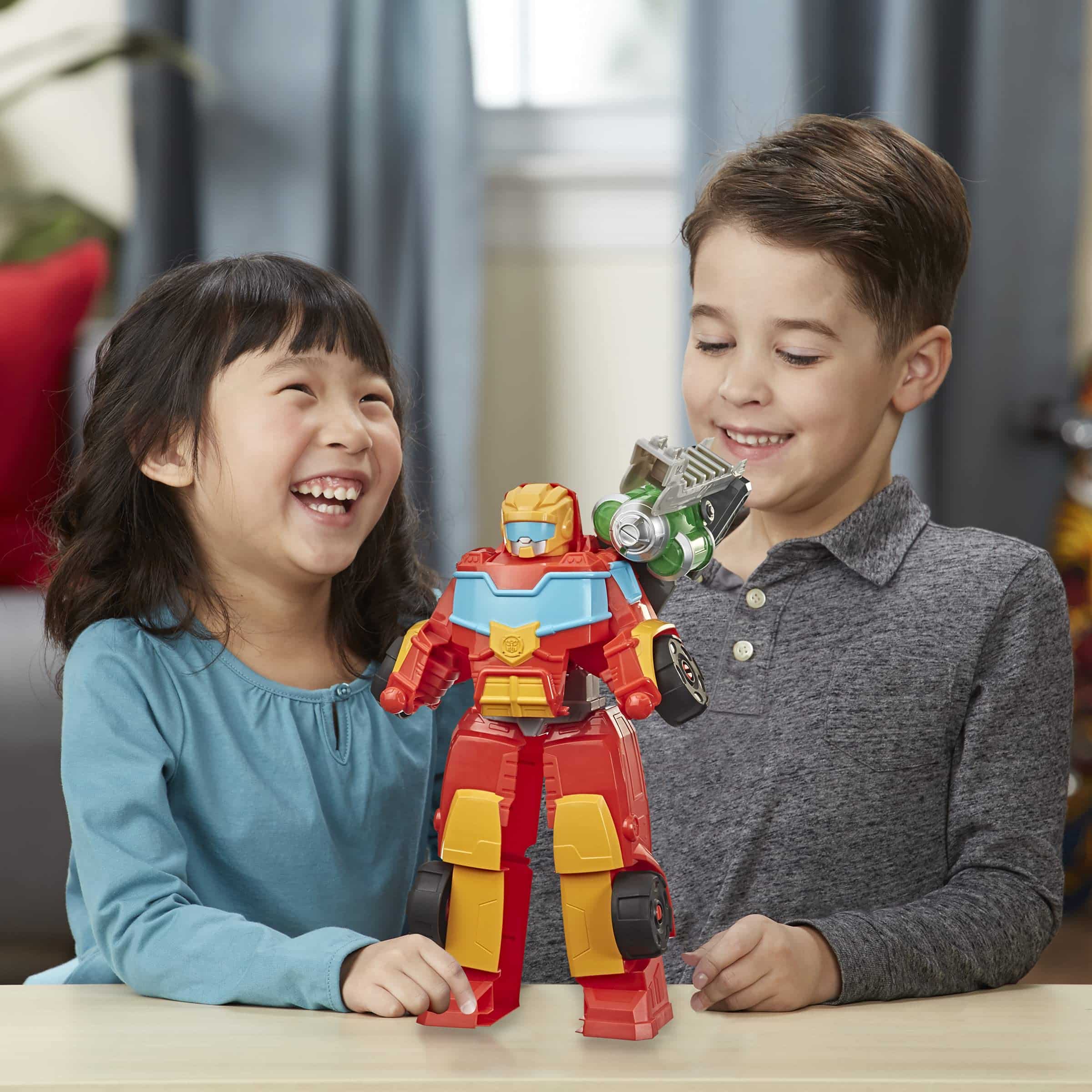 Joyful kids playing together with a colorful robot toy in a cozy, bright setting.