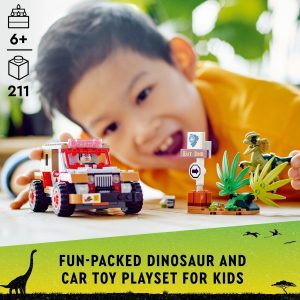 Child joyfully plays with a colorful dinosaur and car adventure toy set indoors.
