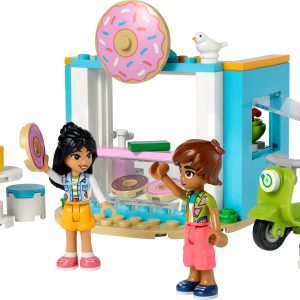 Colorful LEGO donut shop scene with mini-figures enjoying treats and cheerful outdoor seating.
