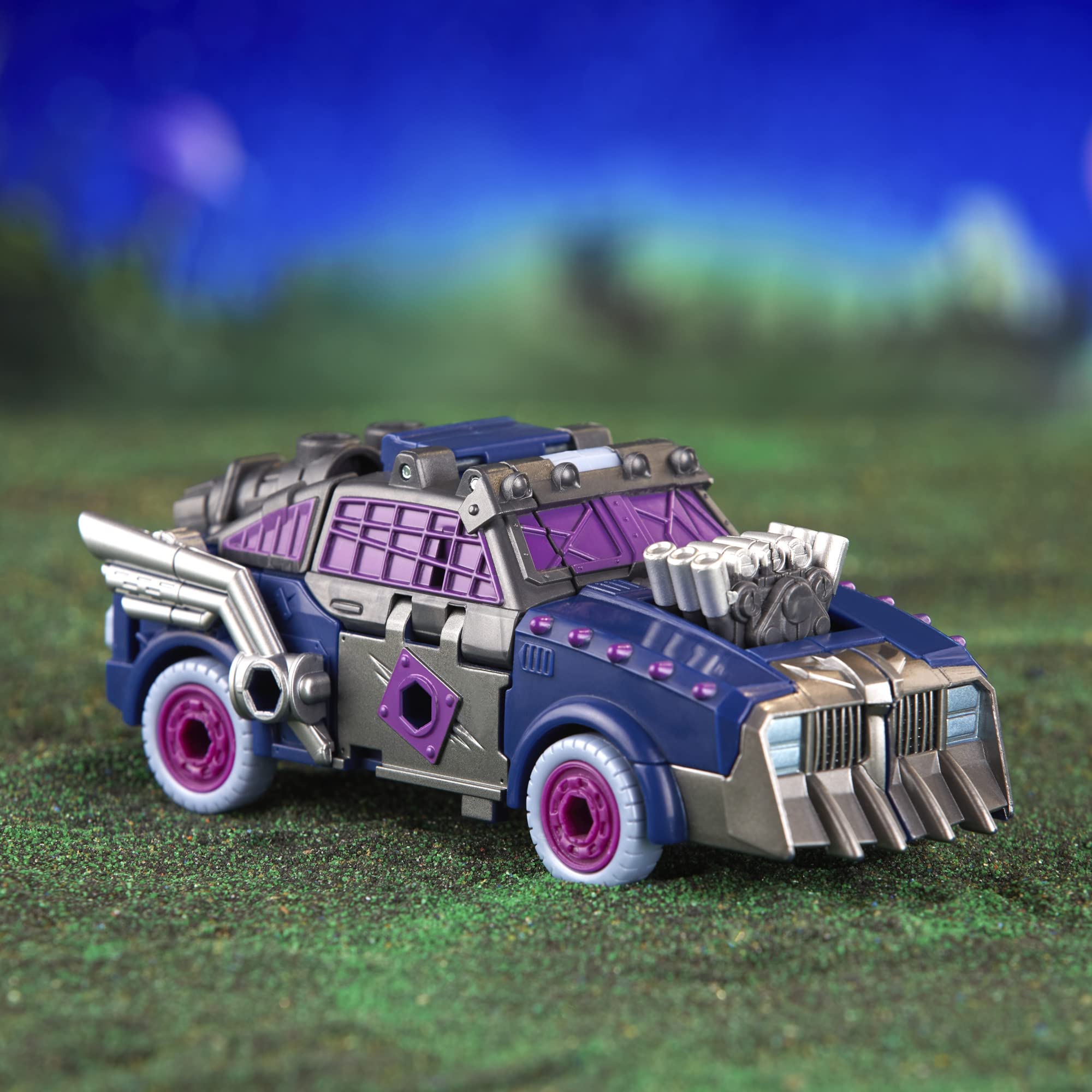 Futuristic muscle car toy in deep blue and silver with bold purple rims and unique design.