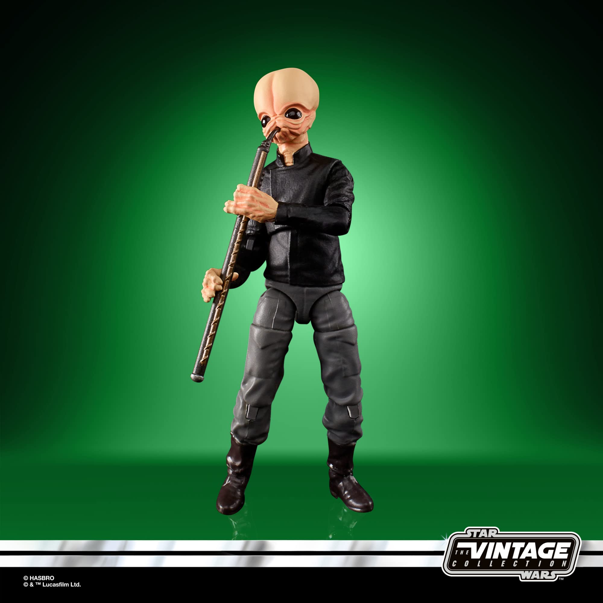 Star Wars alien action figure playing flute against vibrant green background.