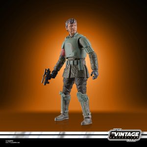 Dynamic Star Wars Vintage Collection action figure in combat-ready pose against vibrant orange backdrop.
