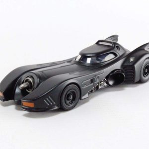 Sleek matte black Batmobile toy model with sharp angles, glowing headlights, and aerodynamic design.
