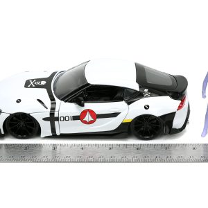 White model car with action figure and ruler display against a clean background.