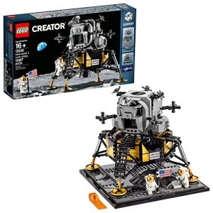 Detailed LEGO Apollo Lunar Module set with astronauts, lunar base, Earth, and stars backdrop.
