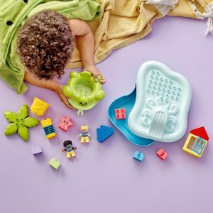 Child plays with colorful toys on a soft lavender mat, fostering creativity and exploration.