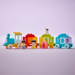 Vibrant toy train set with cheerful figures and a playful dog, inspiring imaginative play.