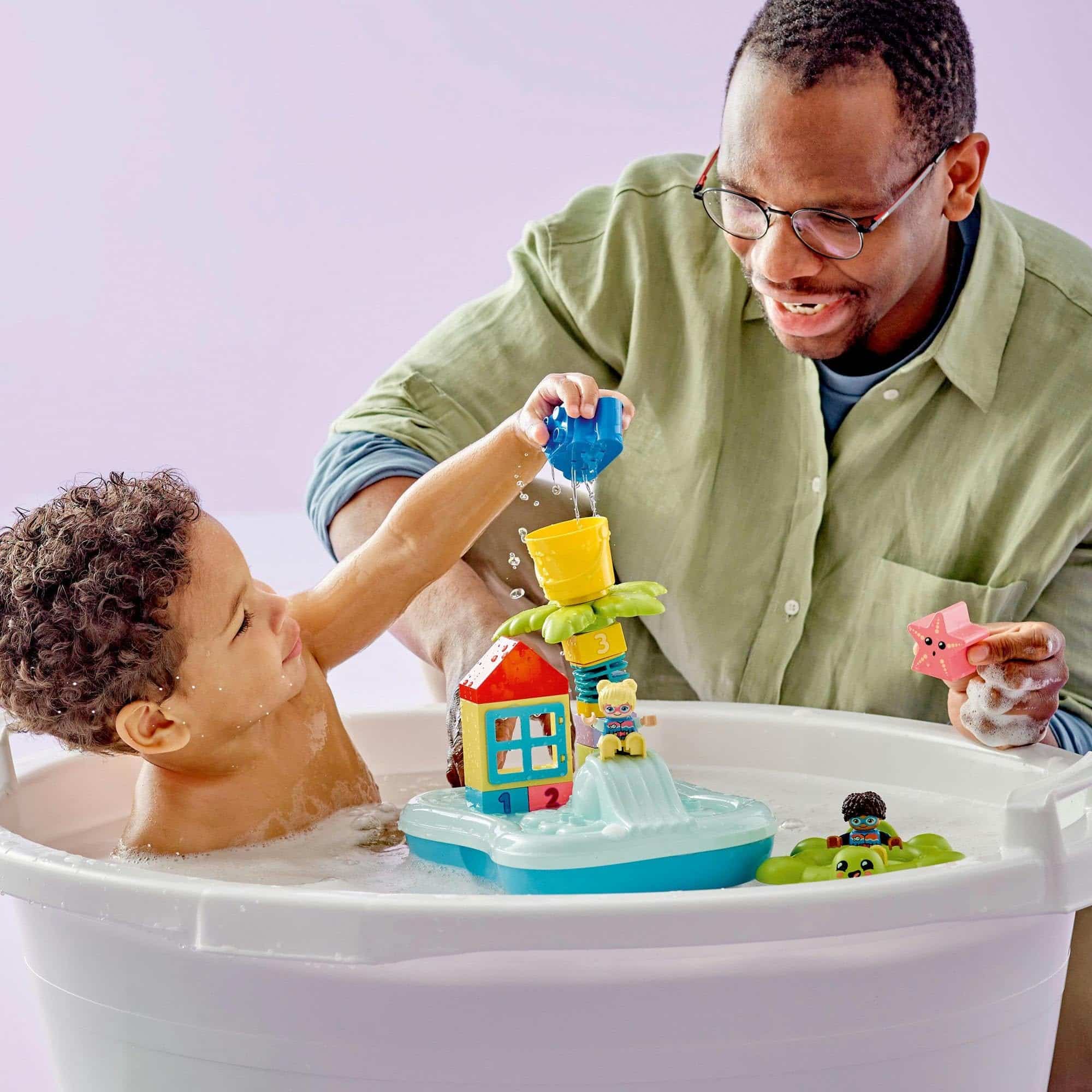 Joyful parent-child bonding during bath time with colorful toys and cheerful smiles.