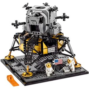 LEGO lunar lander model with astronauts, American flag, and moon surface detail inspired by Apollo.