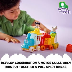 Child assembling a colorful toy train, promoting fine motor skills and creative play.