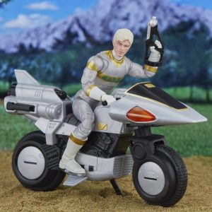 Action figure on futuristic motorcycle in vibrant landscape, showcasing style and adventure.