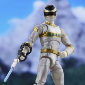 Heroic action figure in white and gold costume, ready for battle against a scenic backdrop.