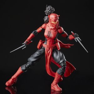 Dynamic red warrior action figure in combat pose, wielding dual blades against black background.