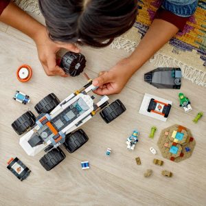 Child immersed in colorful Lego space rover adventure, showcasing creativity and playful exploration.