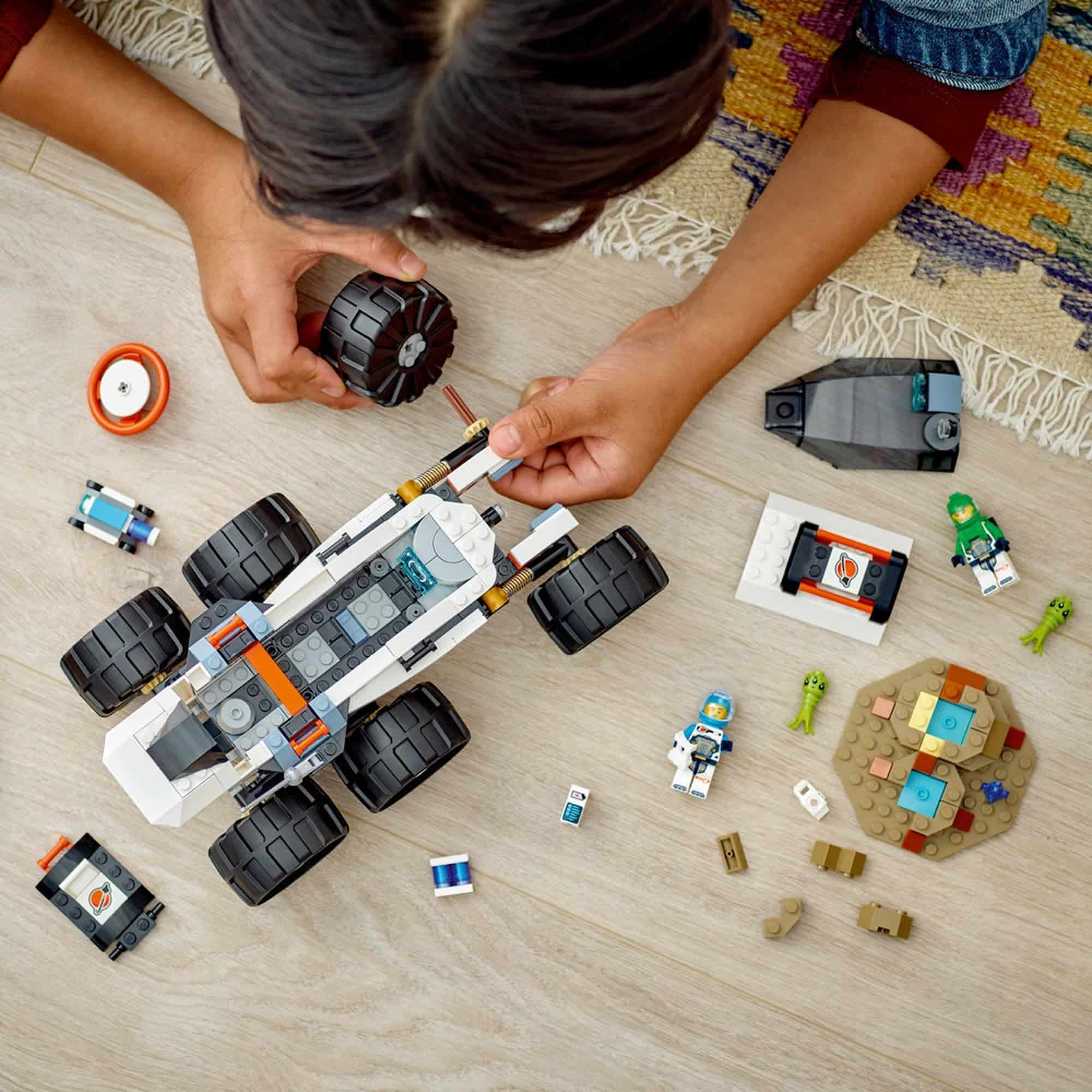 Child immersed in colorful Lego space rover adventure, showcasing creativity and playful exploration.