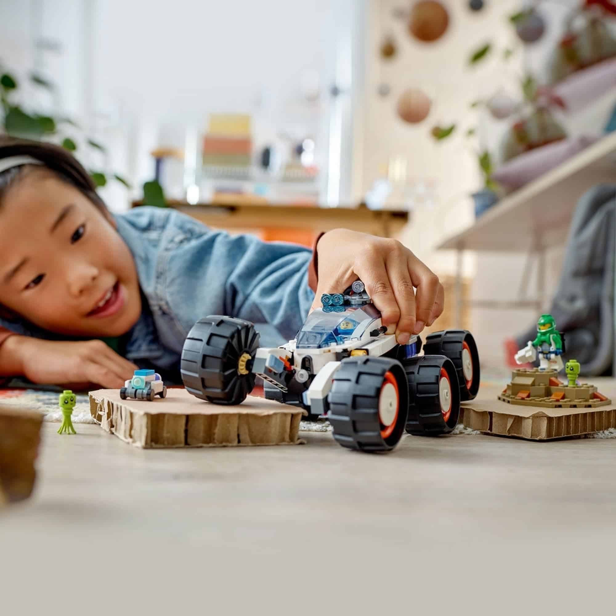 Joyful child plays with colorful toys in a cozy, sunlit indoor setting.