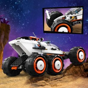 Modular white exploration vehicle with orange accents set against a starry purple sky.