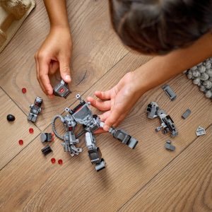 Child focused on building a mechanical toy model, showcasing creativity and hands-on play.
