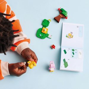 Childs hands engaged in colorful toy assembly, promoting creativity and learning through play.