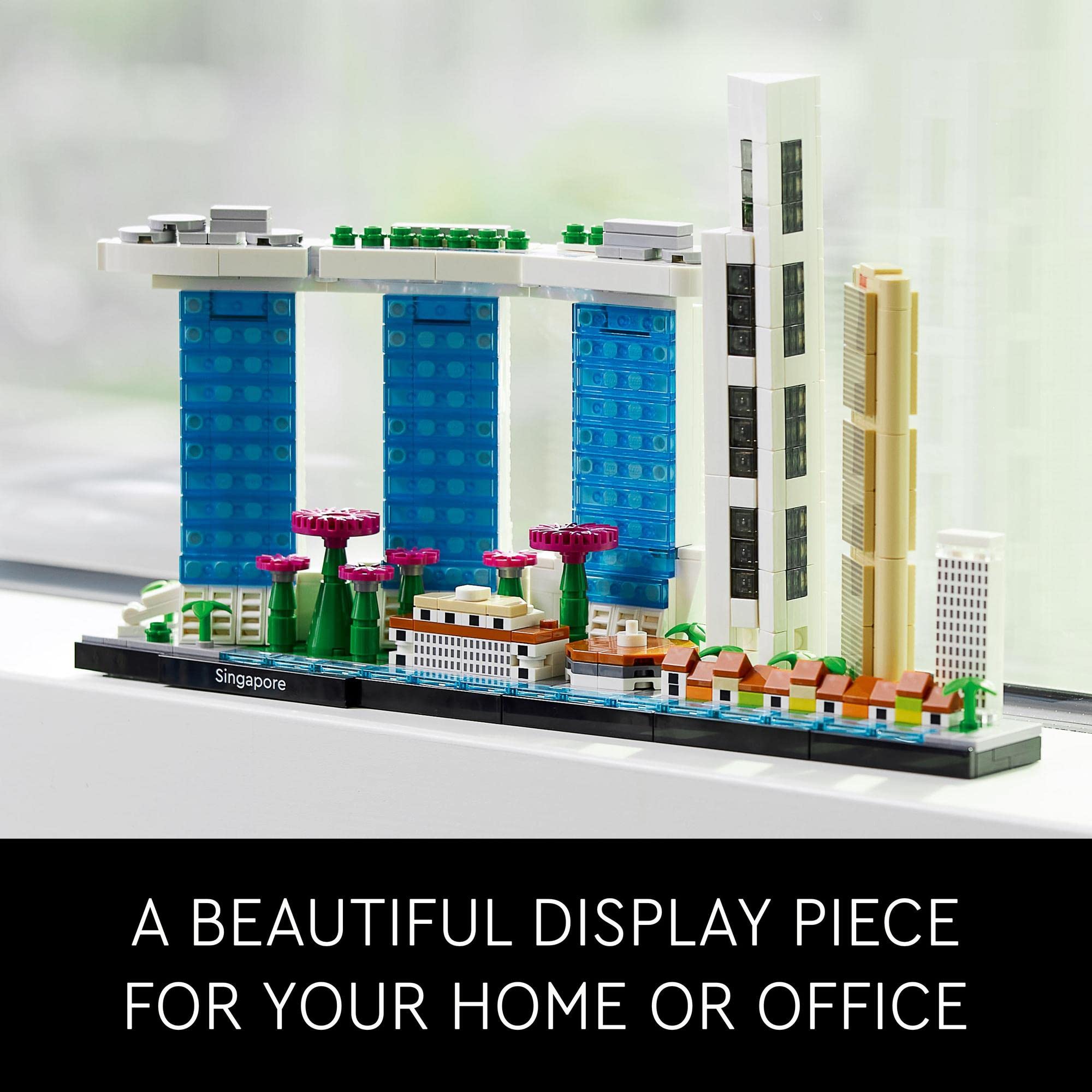 Vibrant miniature cityscape display with modern skyscrapers, greenery, and colorful accents. Perfect decor piece.
