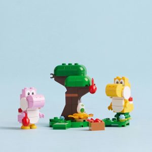 Colorful dinosaur characters playfully interact in a vibrant block building scene with a lush tree.