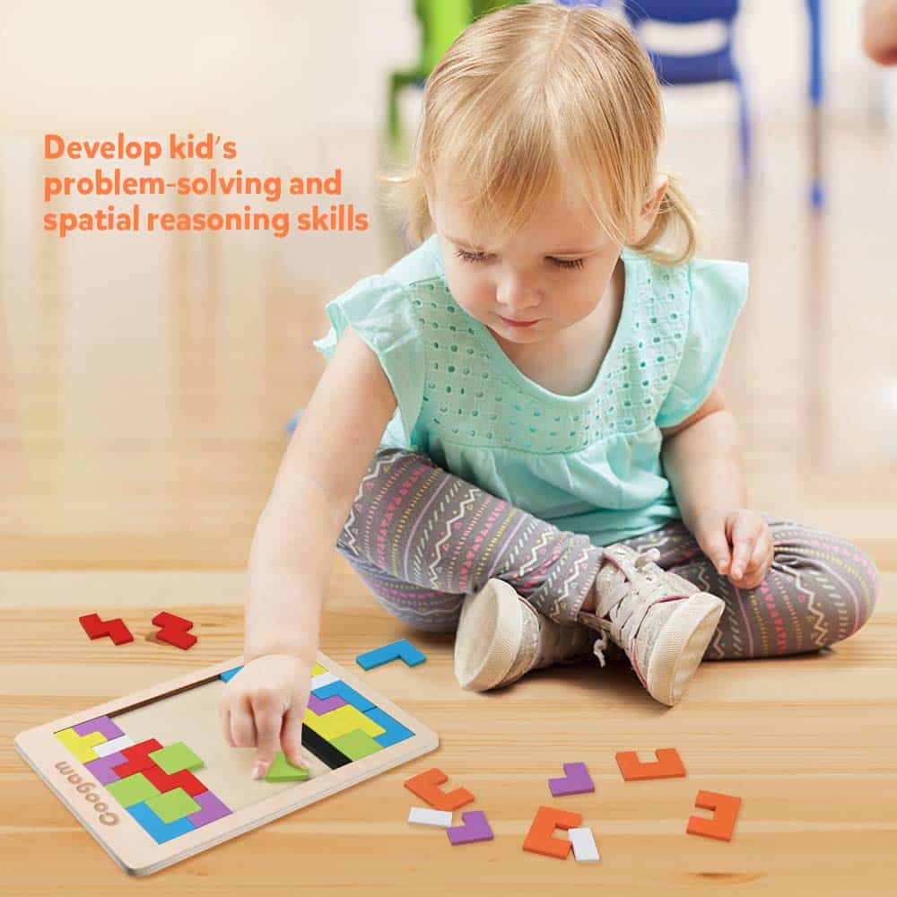 Young girl solving a colorful geometric puzzle, enhancing problem-solving skills in a cheerful classroom.