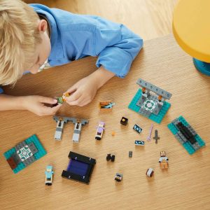 Young boy joyfully plays with colorful LEGO blocks in a bright playroom.