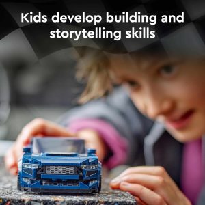 Child playing with a blue toy car, fostering creativity and imaginative storytelling through play.