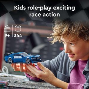 Joyful child races a blue toy car, sparking creativity and imaginative storytelling through play.